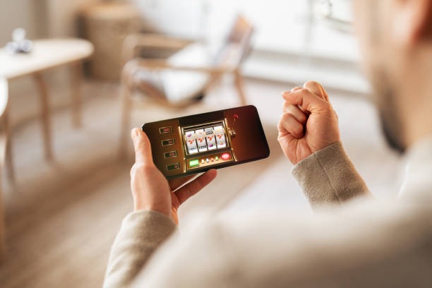 Mobile phone showing gmtoto88 Kembang Kempis betting interface with stake input and game information